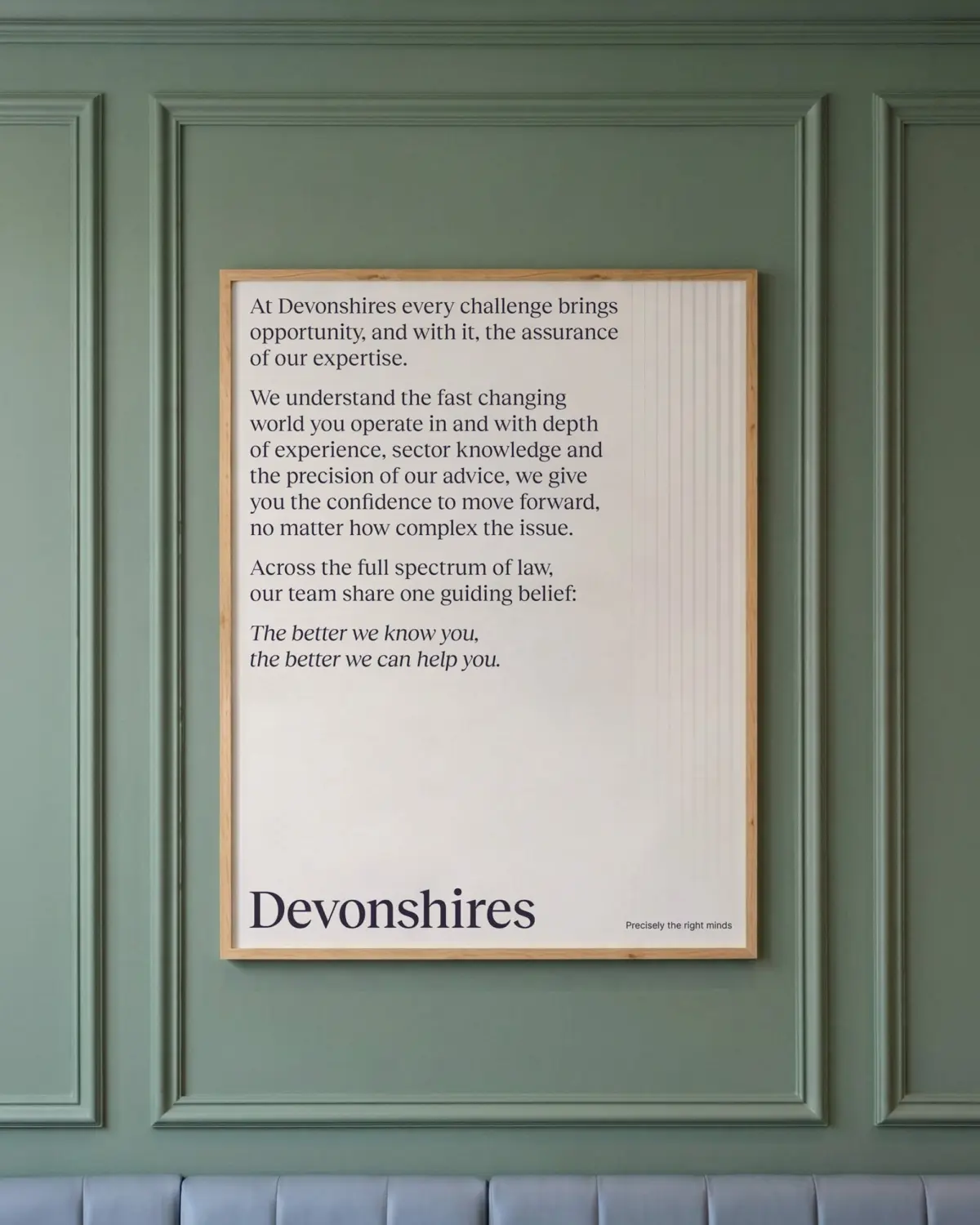 Large poster on a green wall displaying the companies message.
